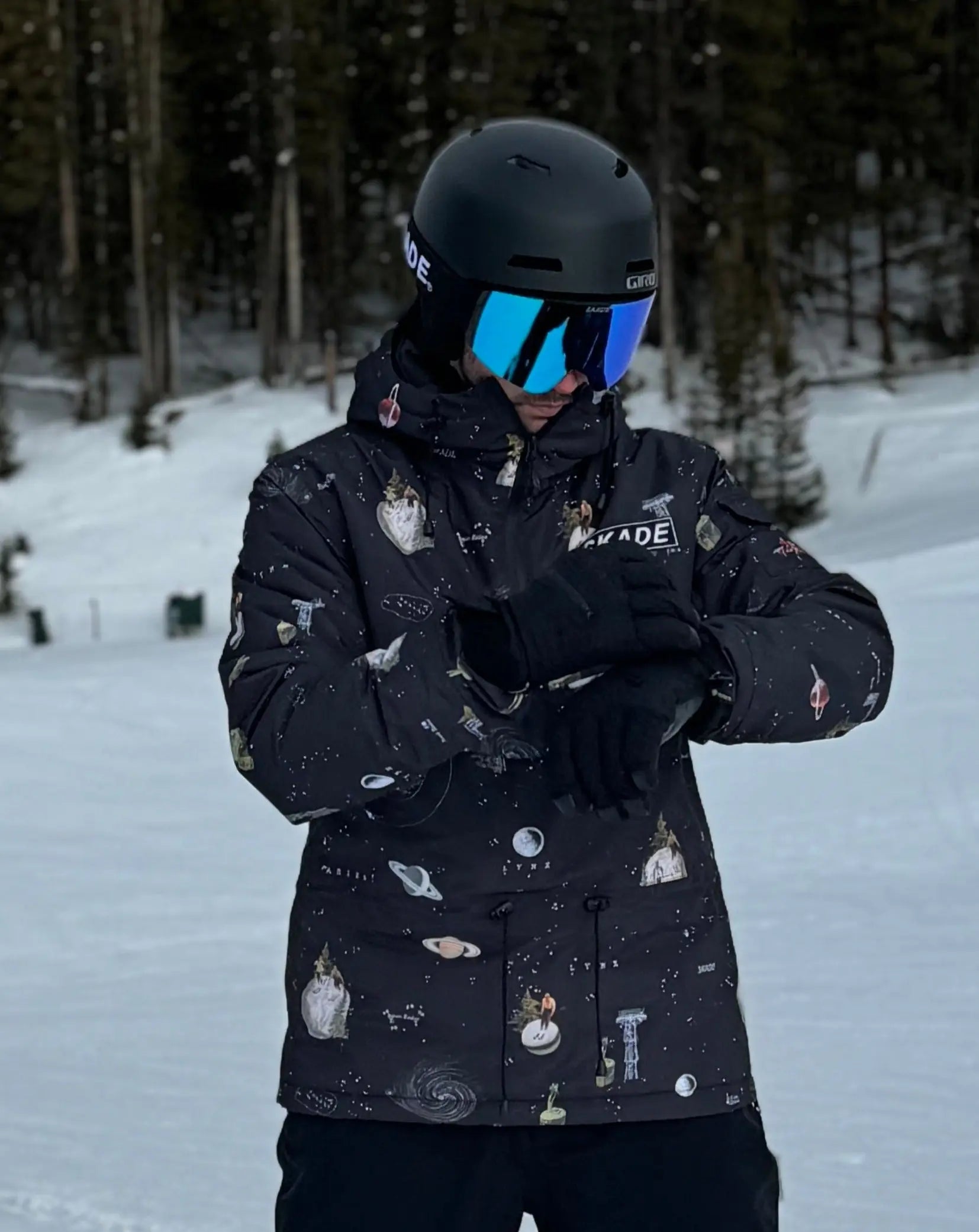 a person standing in the snow with a helmet on