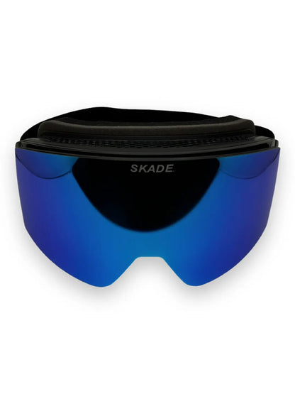 a pair of ski goggles sitting on top of a white surface
